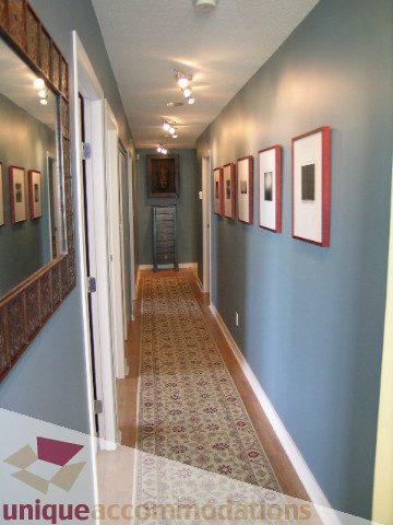 Furnished hallway with framed artwork and patterned carpet. - 3607 - 1033 Marinaside Crescent, Vancouver Downtown