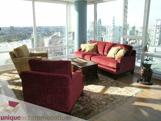 Bright living room with maroon furniture and city view. - 3607 - 1033 Marinaside Crescent, Vancouver Downtown