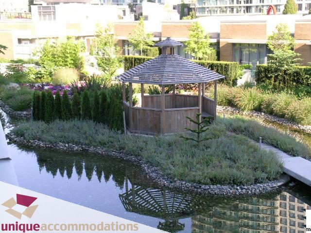 Furnished patio with gazebo, water feature, and lush greenery. - 3607 - 1033 Marinaside Crescent, Vancouver Downtown