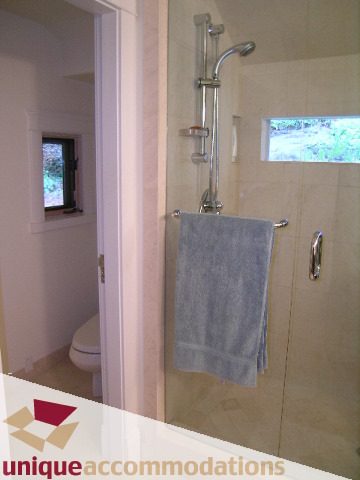 Spacious bathroom with walk-in shower and window view. - 4497 Marine Dr., West Vancouver