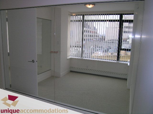 Bright living room with city view and modern furnishings. - 108 - 175 West 1st Street, North Vancouver