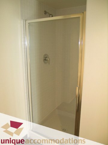 Shower with glass door and modern fixtures. - 108 - 175 West 1st Street, North Vancouver