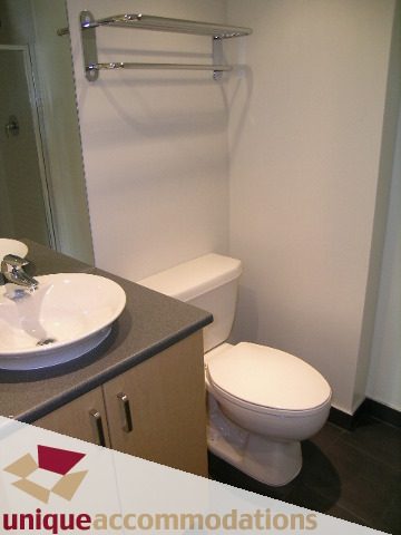 Bathroom with modern sink, toilet, and towel rack. - 108 - 175 West 1st Street, North Vancouver