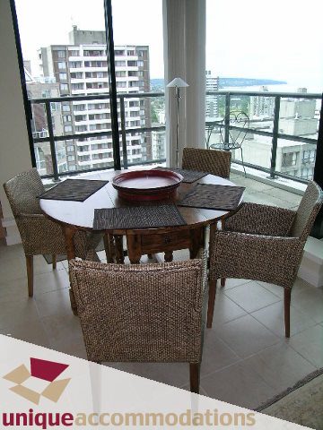 Dining area with wicker furniture and city view. - 1807 - 1003 Burnaby Street, Vancouver Downtown