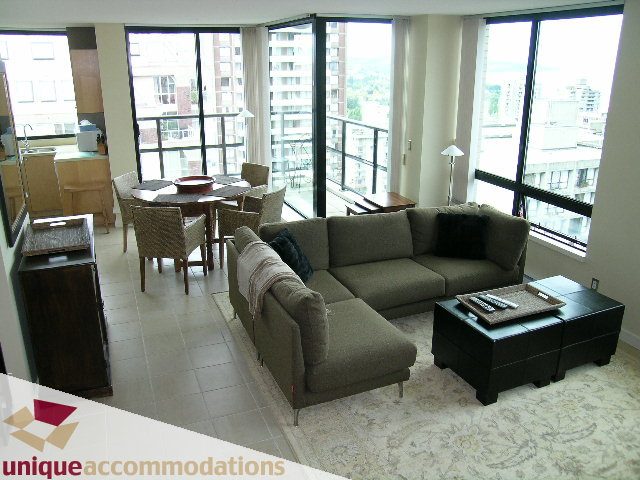 Furnished living room with city view, large windows, and modern furniture. - 1807 - 1003 Burnaby Street, Vancouver Downtown