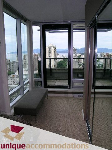 Bright living room with large windows, city view, and modern furnishings. - 1807 - 1003 Burnaby Street, Vancouver Downtown