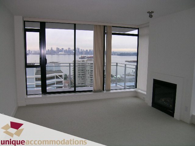 Bright living room with large windows offering a stunning city view and waterfront panorama. - 1404 - 155 W. 1st Street, North Vancouver