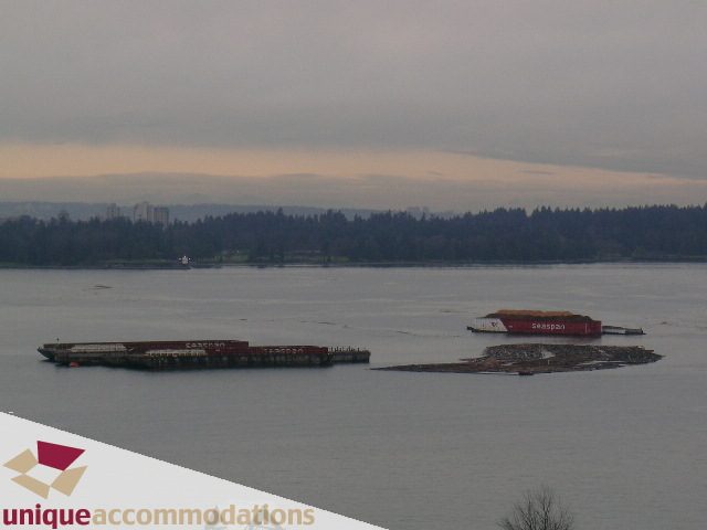 Room with a view of the water and floating barges, serene atmosphere. - 1404 - 155 W. 1st Street, North Vancouver
