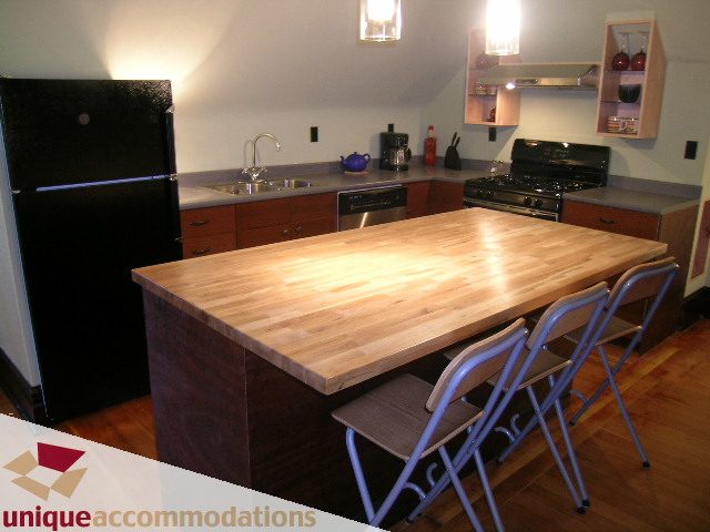 Bright kitchen with wooden countertops, hardwood floors, and modern appliances. - PH - 2812 Yukon St, Vancouver West Side