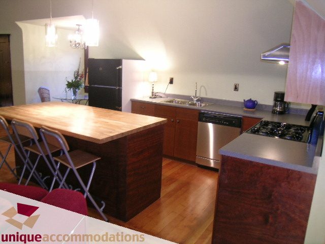 Bright kitchen with wooden countertops, stainless steel appliances, and hardwood floors. - PH - 2812 Yukon St, Vancouver West Side