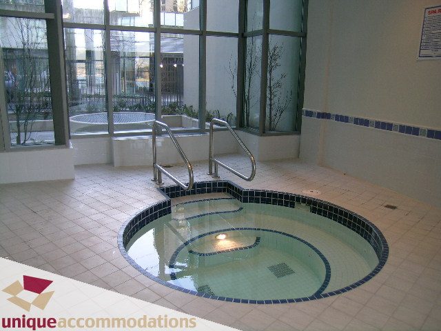 Spacious living room with large windows and a cozy fireplace. - 3101 - 1328 W. Pender Street, Vancouver Downtown