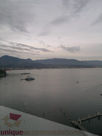 Furnished living room with a stunning city view of mountains and water. - 2101 - 1281 West Cordova Street, Vancouver Downtown