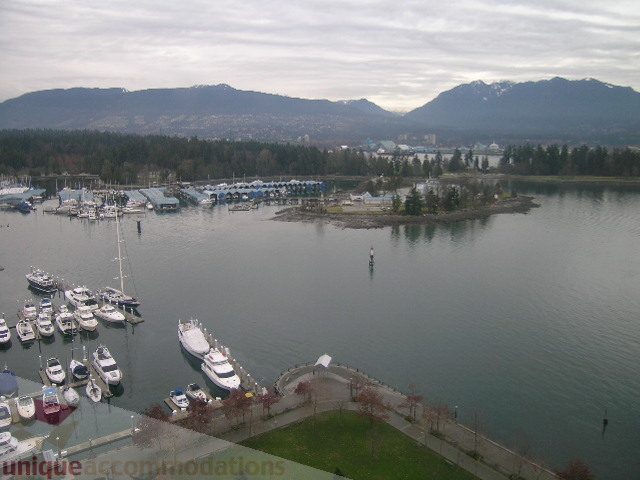 Furnished living room with a stunning city view of the harbor and mountains. - 2101 - 1281 West Cordova Street, Vancouver Downtown