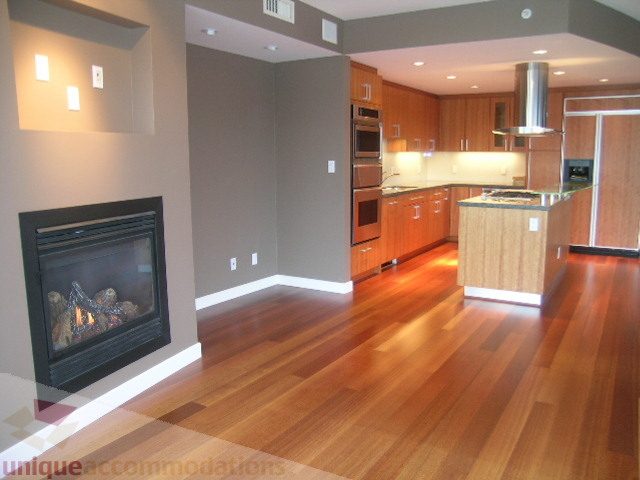 Bright kitchen with hardwood floors and modern appliances, featuring a cozy fireplace. - 2101 - 1281 West Cordova Street, Vancouver Downtown