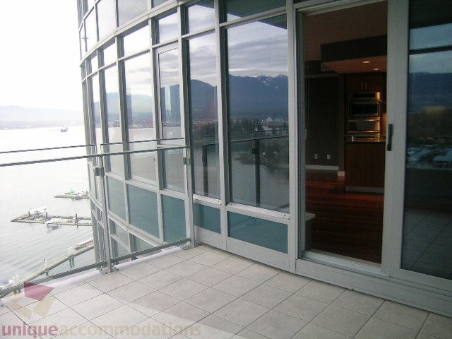 Bright living room with large windows, city view, and modern furnishings. - 2101 - 1281 West Cordova Street, Vancouver Downtown
