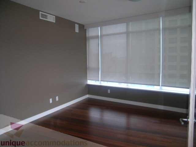 Spacious den with hardwood floors and large windows, offering a city view. - 2101 - 1281 West Cordova Street, Vancouver Downtown