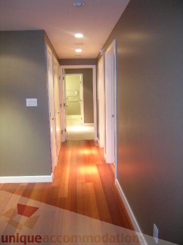 Furnished hallway with hardwood floors and a door leading to another room. - 2101 - 1281 West Cordova Street, Vancouver Downtown
