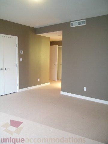Spacious living room with neutral walls and carpeted floor. - 2101 - 1281 West Cordova Street, Vancouver Downtown