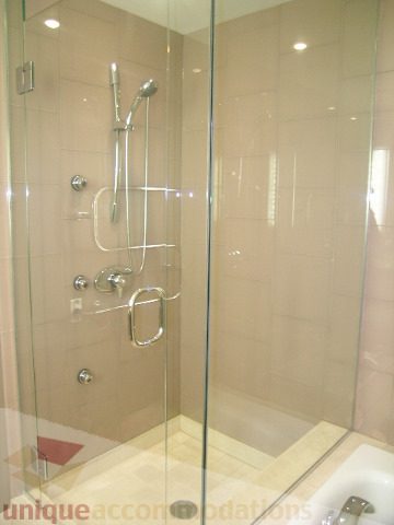 Furnished bathroom with glass shower, modern fixtures, and beige tiles. - 2101 - 1281 West Cordova Street, Vancouver Downtown