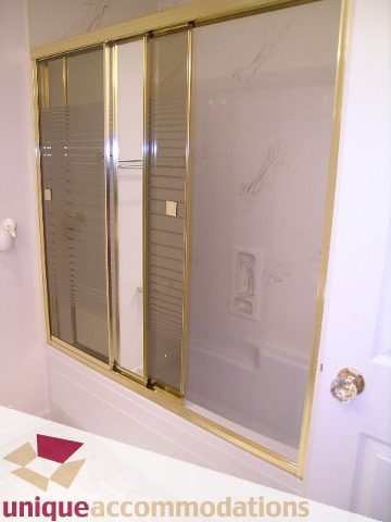 Bathroom with frosted glass shower doors and brass trim. - 1416 Chartwell Drive, West Vancouver