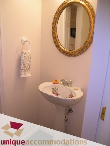 Bathroom with ornate mirror and floral sink. - 1416 Chartwell Drive, West Vancouver