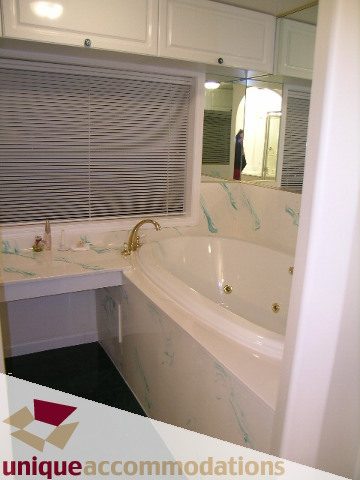 Bathroom with marble countertops and a bathtub, clean and modern. - 1416 Chartwell Drive, West Vancouver