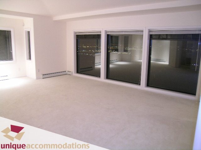 Spacious living room with large windows and city view. - 1416 Chartwell Drive, West Vancouver