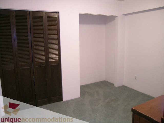 Furnished den with dark wood closet and carpeted floor. - 4655 Clovelly Walk, West Vancouver