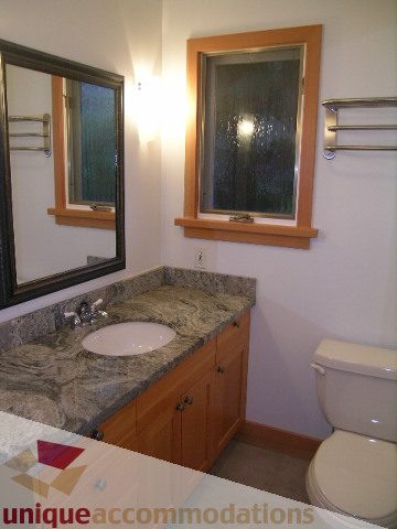 Bathroom with granite countertops and wooden cabinets. - 4655 Clovelly Walk, West Vancouver