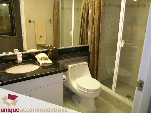 Furnished bathroom with black countertop and glass shower door. - 1902 - 560 Cardero Street, Vancouver Downtown