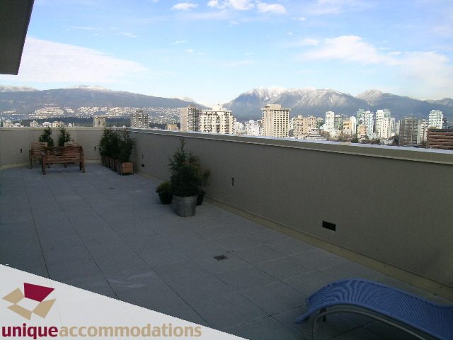 Furnished rooftop patio with city view and mountains in the background. - 2901 - 1005 Beach Avenue, Vancouver Downtown