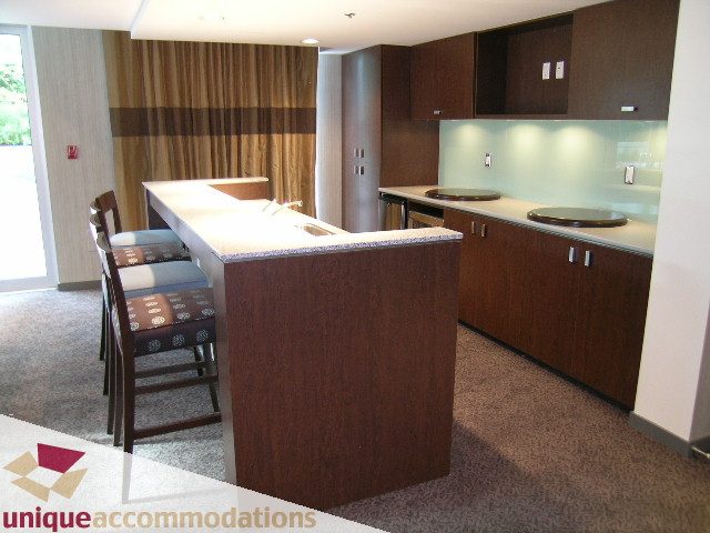 Furnished kitchen with modern countertops and dark wood cabinetry. - 2901 - 1005 Beach Avenue, Vancouver Downtown