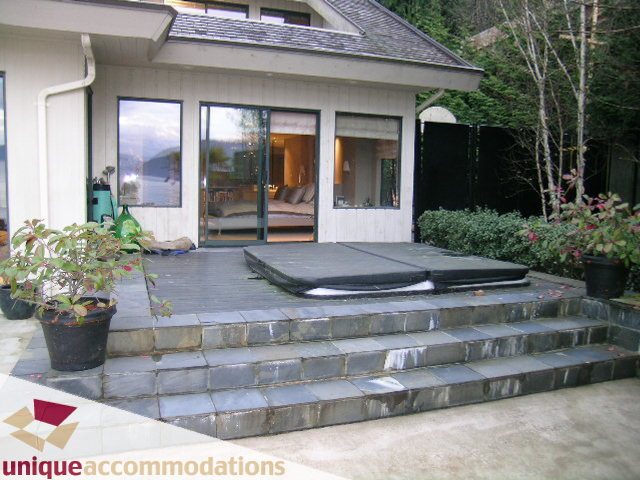 Furnished living room with large windows and outdoor patio access. - 2 Strachan Point Road, West Vancouver