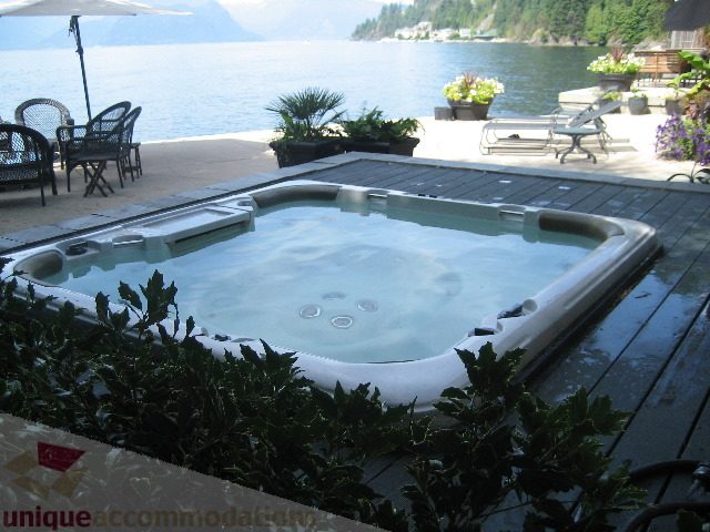 Jacuzzi with a stunning view of the water and lush greenery. - 2 Strachan Point Road, West Vancouver