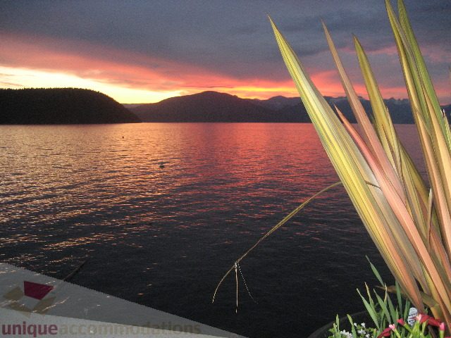 Furnished living room with a stunning sunset view over the water. - 2 Strachan Point Road, West Vancouver