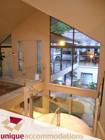 Furnished living room with glass walls, modern design, and city view. - 2 Strachan Point Road, West Vancouver