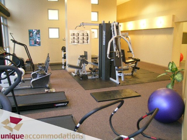 Bright gym with cardio equipment and free weights, clean and organized. - 2001 - 1238 Richards Street, Vancouver Downtown