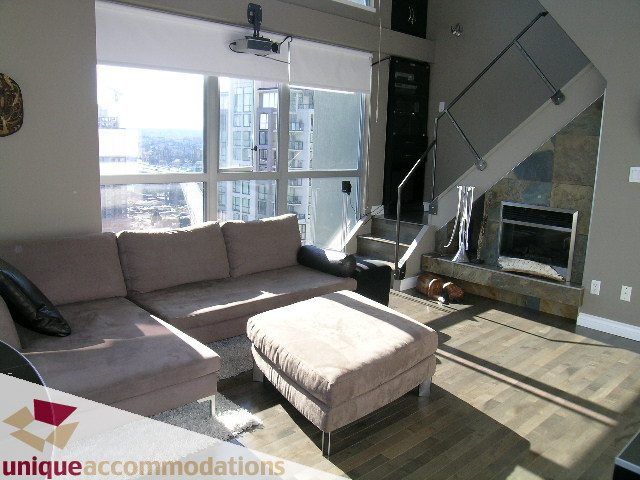 Bright living room with city view, modern furnishings, and hardwood floors. - 2001 - 1238 Richards Street, Vancouver Downtown