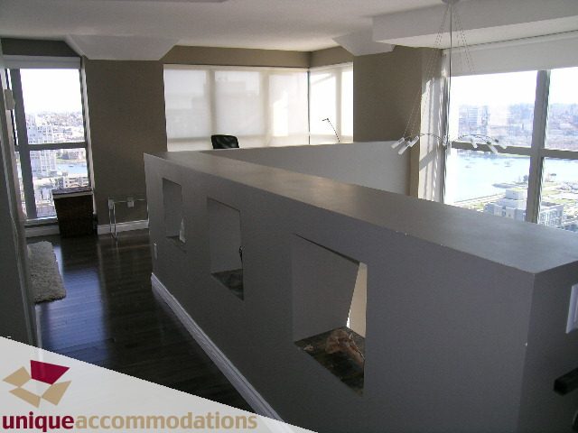Bright kitchen with modern white countertops, hardwood floors, and a city view. - 2001 - 1238 Richards Street, Vancouver Downtown