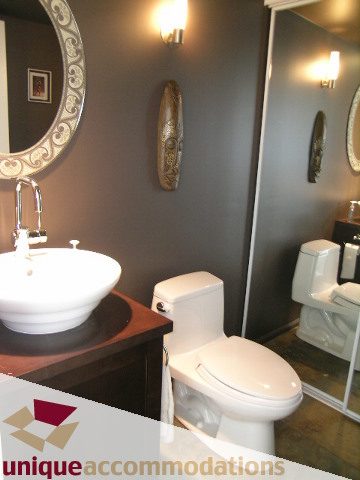 Bathroom with modern sink, dark walls, and wall-mounted mirror. - 2001 - 1238 Richards Street, Vancouver Downtown