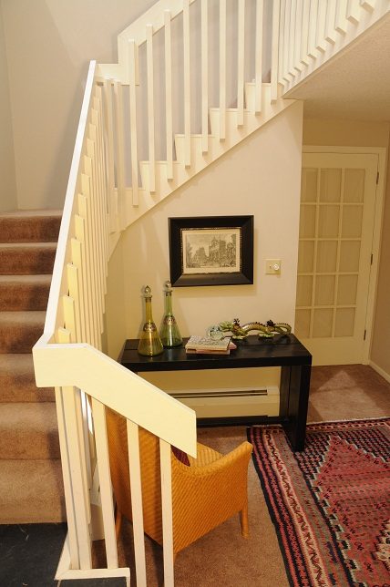 Staircase landing with framed artwork and decorative items, carpeted floor. - Guest House - 440 Stevens Drive, West Vancouver