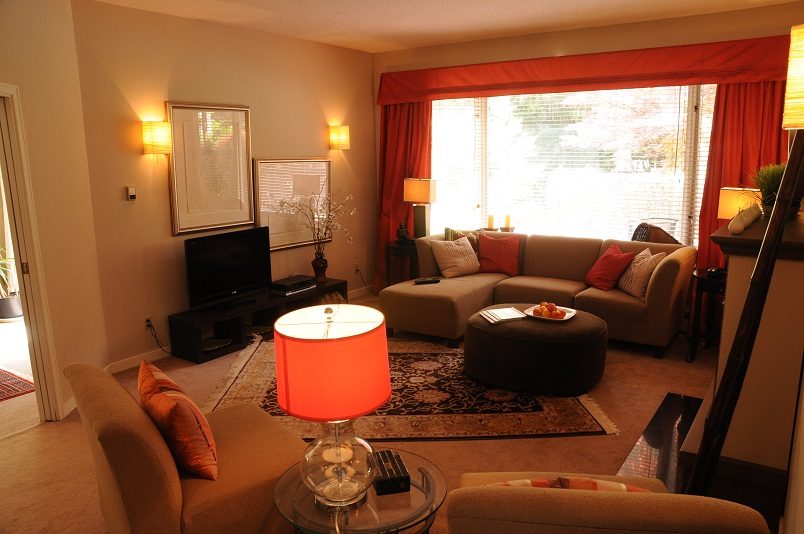 Furnished living room with orange accents, large window, and comfortable seating. - Guest House - 440 Stevens Drive, West Vancouver