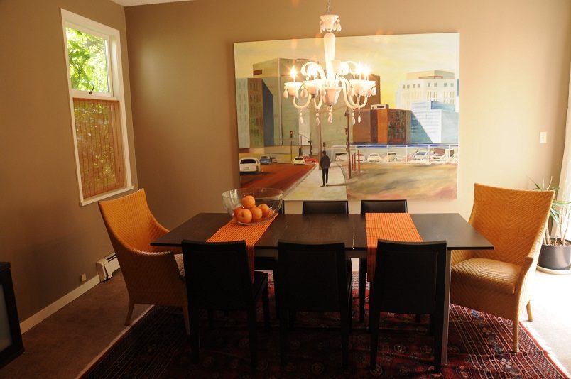 Dining room with a chandelier, cityscape painting, and orange chairs. - Guest House - 440 Stevens Drive, West Vancouver