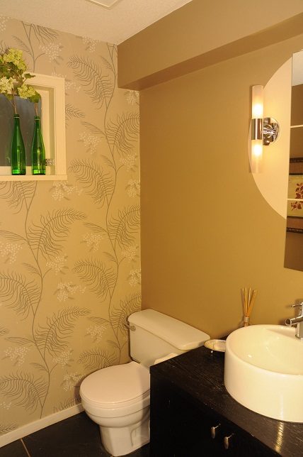 Bathroom with floral wallpaper, modern sink, and wall-mounted light fixture. - Guest House - 440 Stevens Drive, West Vancouver