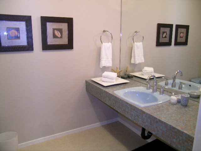 Bright bathroom with mosaic countertop and framed artwork. - Guest House - 440 Stevens Drive, West Vancouver