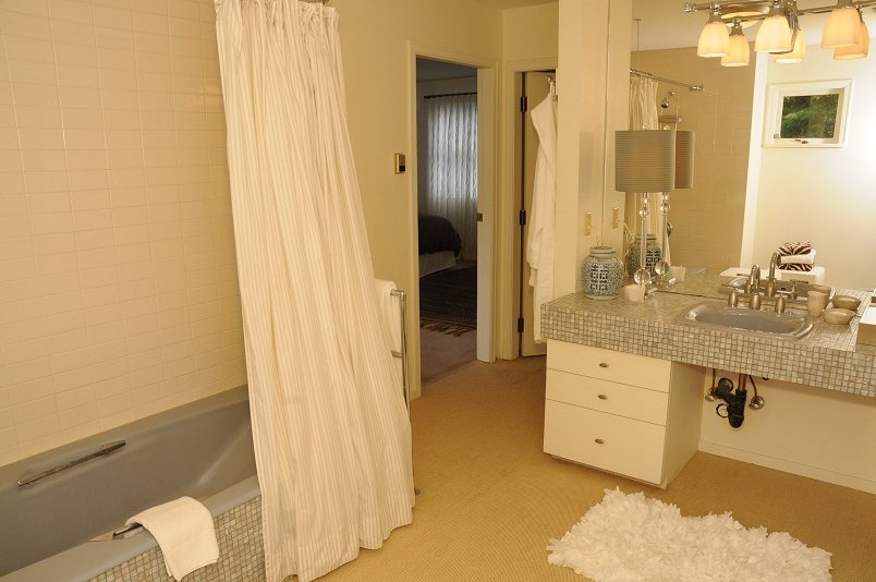 Spacious bathroom with mosaic countertops and a bathtub. - Guest House - 440 Stevens Drive, West Vancouver