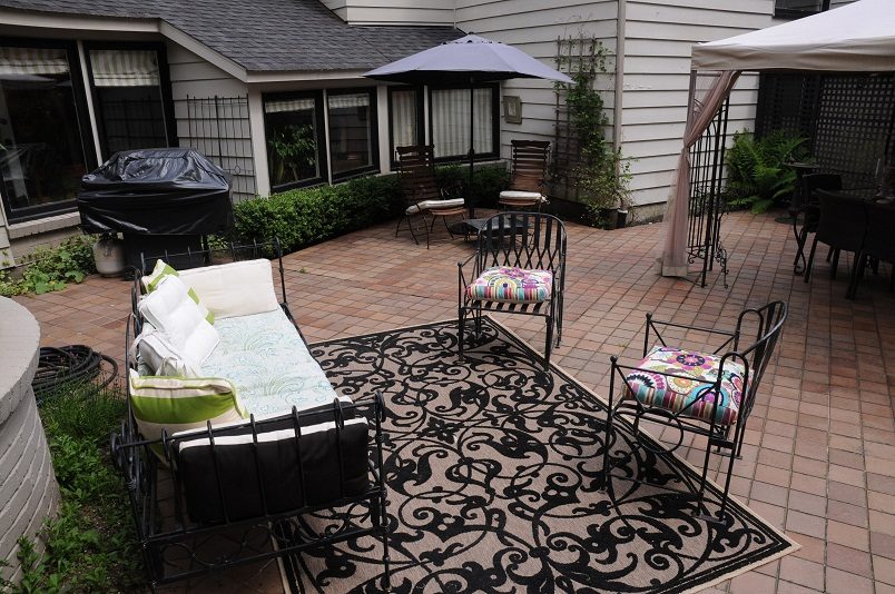 Furnished patio with outdoor furniture, black and white rug, and privacy screen. - Guest House - 440 Stevens Drive, West Vancouver