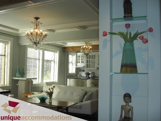 Bright living room with modern decor, glass shelves, and chandelier. - 45 - 777 Burrard Street, Vancouver Downtown