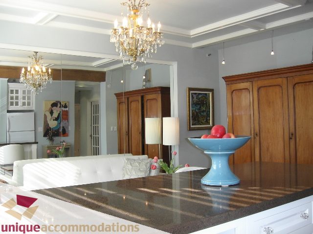 Bright kitchen with granite countertops, chandelier, and wooden cabinets. - 45 - 777 Burrard Street, Vancouver Downtown