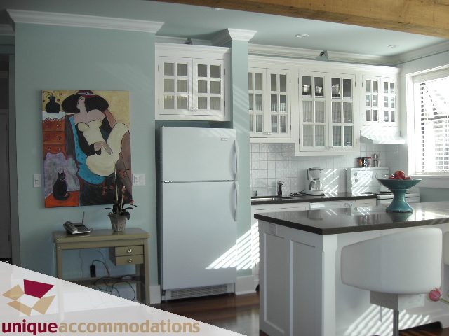 Bright kitchen with white cabinets, stainless steel appliances, and a large island. - 45 - 777 Burrard Street, Vancouver Downtown